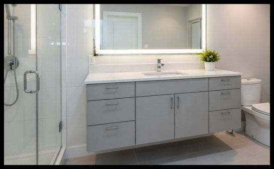 Custom bathroom vanity featuring triple drawer banks on both sides with a central double-door storage cabinet for maximum organization.