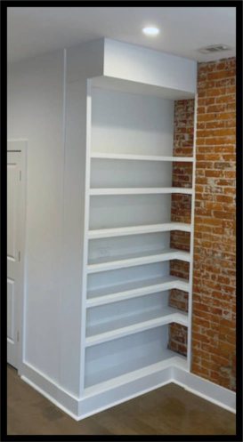 Custom L-shaped white maple built-in with 1.5-inch adjustable shelving, featuring a specialized high fascia integration to hide overhead HVAC ductwork.