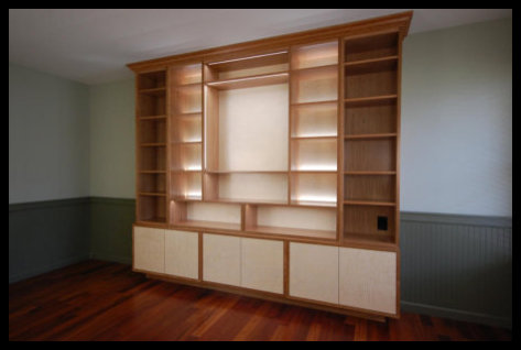 Custom 9x8 cherry built-in with quilted curly maple accents and integrated LED lighting; solid wood, no particle board.