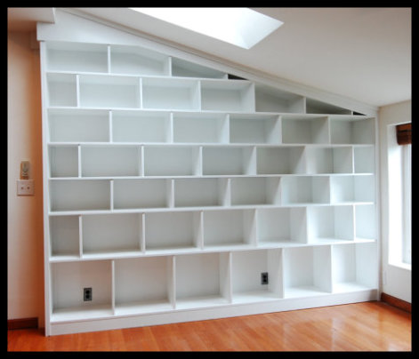 14ft wide staggered custom bookcases in white painted Hard Rock Maple, designed for art book collections.