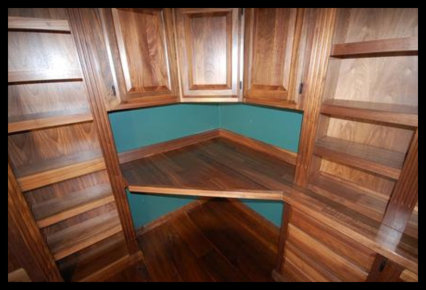 High-end walnut home library with integrated desktop workspace and custom cabinetry. No particle board used.