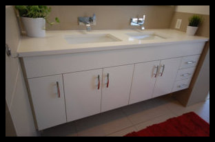 Premier showcase of a custom white floating bathroom vanity featuring five doors, three drawers, and a premium double bowl inlaid sink.